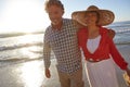 Love and laughter at sunset. a mature couple enjoying a late afternoon walk on the beach. Royalty Free Stock Photo