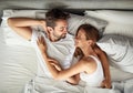 Love in lazy mode. a happy young couple relaxing in bed together at home. Royalty Free Stock Photo