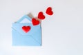 Love letter, blue envelope and flying red hearts