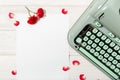 Love letter. Desk with blank paper, retro typewriter and red roses and petals Royalty Free Stock Photo