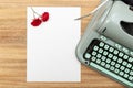 Love letter. Desk with blank paper, retro typewriter and red roses and petals Royalty Free Stock Photo
