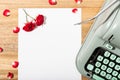 Love letter. Desk with blank paper, retro typewriter and red roses and petals Royalty Free Stock Photo