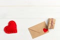 Love letter envelope with red heart and gift box on wooden background Royalty Free Stock Photo