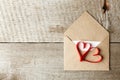 Love letter envelope with red hearts on wooden background, valentine romance closeup Royalty Free Stock Photo