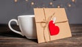 Love letter with a heart next to a cup on a background of lights, love and valentine concept on a wooden table Royalty Free Stock Photo