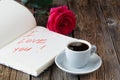 Love letter notepad, red roses and coffee cup on wooden table. Valentines day concept Royalty Free Stock Photo