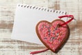 Love letter template on paper and cookie heart with red ribbon on wooden rustic desk