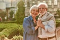 Love is life. Portrait of cheerful happy senior couple bonding to each other and holding hands while standing in the Royalty Free Stock Photo