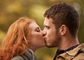 Love without limits. a happy young couple sharing a kiss outdoors.