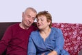 Love lives forever. Senior couple at home. Handsome old man and attractive old woman hugging and enjoying vacation together Royalty Free Stock Photo