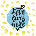 Love lives here - hand drawn lettering phrase on the polka dot grunge background. Fun brush ink inscription for