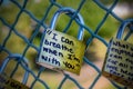 Love locks on fence on bridge reads I can breathe when I`m with you Royalty Free Stock Photo