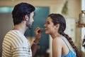 Love makes everything taste better. Shot of an affectionate young couple snacking while preparing a meal in their