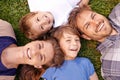 Love makes a family. Portrait of a loving family lying on the grass together. Royalty Free Stock Photo