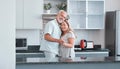 Love, marriage and dance with a senior couple in the kitchen of their home together for bonding or romance. Portrait Royalty Free Stock Photo