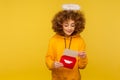 Love message. Portrait of curly-haired angelic woman with nimbus reading letter or greeting card Royalty Free Stock Photo