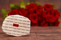 Love message with Red roses in a bunch as a background. Royalty Free Stock Photo