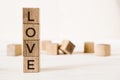 Love message written in wooden blocks on light background