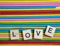 Love message written in wooden blocks placed on colourful wood s Royalty Free Stock Photo