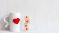 Love message written in wooden blocks with red heart and cup coffee morning, Royalty Free Stock Photo