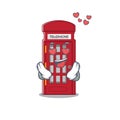 In love miniature telephone booth above cartoon table Royalty Free Stock Photo