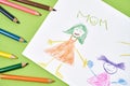 Love mom. Creative child drawing for mothers day and colored pencils on a green background Royalty Free Stock Photo