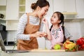 Love moment of Asian family mom and daughter helping preparing vegetable salad in kitchen at home Royalty Free Stock Photo