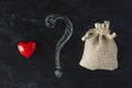 Love or money choise. red heart and a bag with money. Chackboard wih question mark. Making right decision