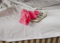 Love for money is prostitution. Crumpled bed, underwear and money as payment for sex