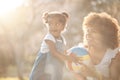 Love, mother and girl with ball in a park for playing, bond and child development in nature. Toy, smile and kid with Royalty Free Stock Photo