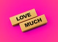 Love much words on wooden blocks with pink background 3d illustration