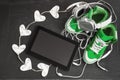 Love for music concept. Green sneakers, headphones, tablet and h
