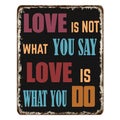 Love is not what you say love is what you do vintage rusty metal sign Royalty Free Stock Photo