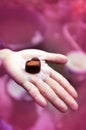 Love note on black chocolate heart in Woman`s hands, Effect Pink recolor