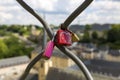 Love padlocks on the fence on the city background.