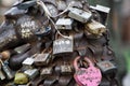 Love padlocks at rusty statue of bronze lion