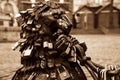 Love padlocks at rusty statue of bronze lion