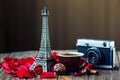 Love Paris! Rose, vintage camera, Eiffel tower, coffee cup, chocolate and cinnamon sticks on wooden background. St Valentine`s Day