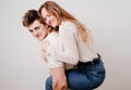 love, passionate and beautiful couple have fun against the white wall.