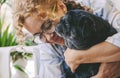 Love people and dog animal concept with happy adult caucasian woman and black old pug hugging and loving with tendernes together. Royalty Free Stock Photo