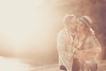 Love people and relationship adult couple concept with man and woman whispering and kissing each other outdoor during a coloured Royalty Free Stock Photo
