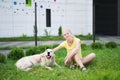 Love for pets - a young blonde woman resting with her dog on the grass Royalty Free Stock Photo