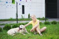 Love for pets - a young blonde woman resting with her dog on the grass Royalty Free Stock Photo