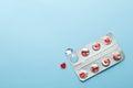 Love pills. Blister pack with red heart shaped pills. Tablets for lovers or potency. Blue background. Copy space for Royalty Free Stock Photo