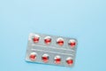 Love pills. Blister pack with red heart shaped pills. Tablets for lovers or potency. Blue background. Copy space for Royalty Free Stock Photo