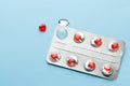 Love pills. Blister pack with red heart shaped pills. Tablets for lovers or potency. Blue background Royalty Free Stock Photo