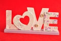 Love in pink letters isolated on a red background