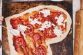 Love pizza. Baked heart-shaped homemade pizza