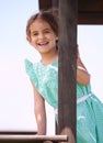 She love playing outside. Portrait of a little girl playing on a jungle gym on a sunny day. Royalty Free Stock Photo