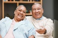 Love, portrait and senior couple watching tv, having fun and laughing at comic movie in living room. Valentines, romance Royalty Free Stock Photo